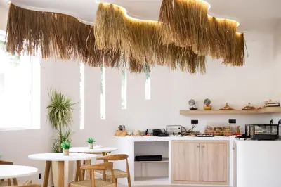 a kitchen with two tables and chairs and ceilings at Stay Helios in Faliraki