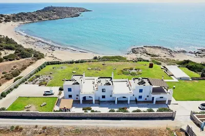 an aerial view of a large white house next to the beach at Nerida Beachfront Villas in Plimmiri