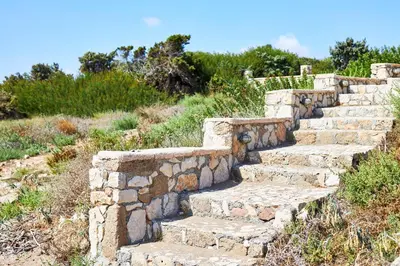 a set of stone stairs on a hill at Nerida Beachfront Villas in Plimmiri