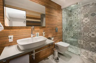 a bathroom with a sink and a toilet and a mirror at Lindos 4 me Apartment in Líndos