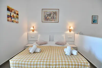 a bedroom with a bed with two pillows on it at Summer View in Theologos