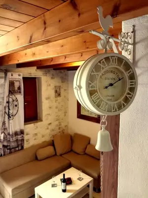 a clock hanging on the wall in a living room at The White House of Rhodes in Rhodes Town
