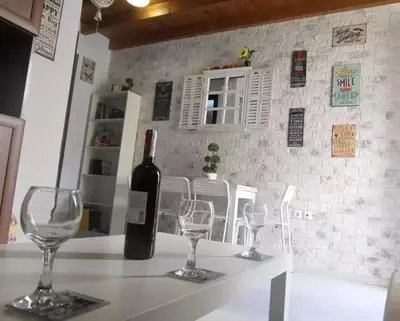 a bottle of wine sitting on a table with two wine glasses at The White House of Rhodes in Rhodes Town