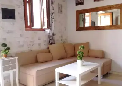 a living room with a couch and a table at The White House of Rhodes in Rhodes Town