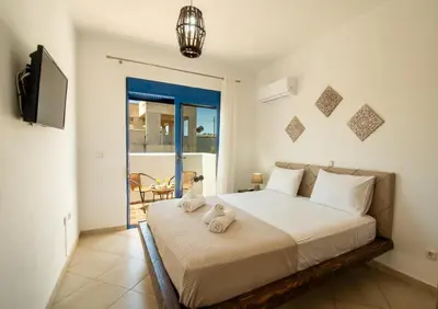 a bedroom with a bed with two towels on it at Maripaul Family Villa in Lardos