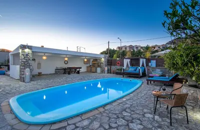 a large blue swimming pool in a yard at Maripaul Family Villa in Lardos