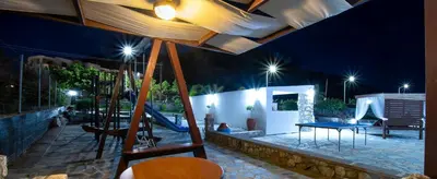 a playground with a slide and a table and swings at Maripaul Family Villa in Lardos