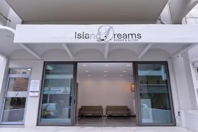 a building with a sign that reads ishtar teams at Island Dreams Rooms & Suites in Rhodes Town
