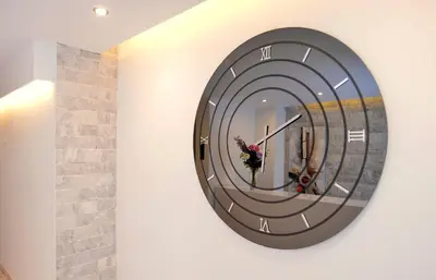 a large clock on a wall with a mirror at Island Dreams Rooms & Suites in Rhodes Town