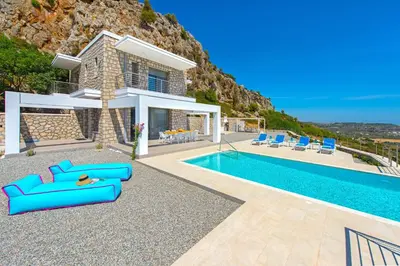a villa with a swimming pool and a house at Villa Olympos in Afantou