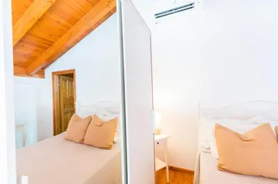 a bedroom with a bed and a mirror at Myrtia in Symi
