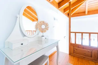 a dressing table in a room with a mirror at Myrtia in Symi