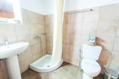 a bathroom with a toilet and a sink and a shower at Myrtia in Symi