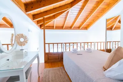 a bedroom with a bed and a glass table at Myrtia in Symi