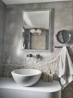 a bathroom with a large white sink and a mirror at Haraki Village in Haraki