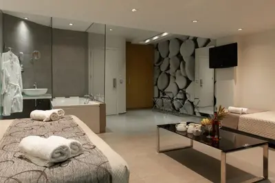 a hotel room with a bed and a bath tub at Atlantis Boutique City Hotel in Rhodes Town