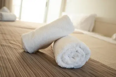 a roll of toilet paper sitting on a bed at Atlantis Boutique City Hotel in Rhodes Town