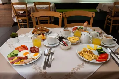 a table with plates of breakfast food on it at Atlantis Boutique City Hotel in Rhodes Town