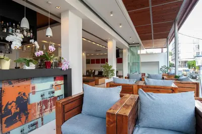 a restaurant with wooden tables and blue chairs at Atlantis Boutique City Hotel in Rhodes Town
