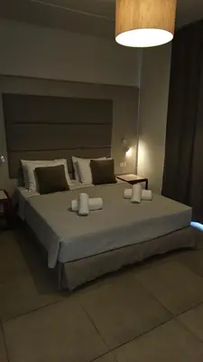 a bedroom with a large bed with pillows at Atlantis Boutique City Hotel in Rhodes Town