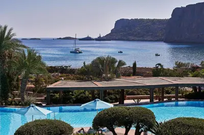 a swimming pool with a view of a body of water at Aquagrand Artistic Luxury Beach Resort - Adults Only in Líndos
