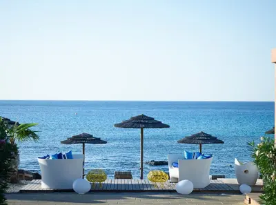 a group of chairs and umbrellas on the beach at Aquagrand Artistic Luxury Beach Resort - Adults Only in Líndos