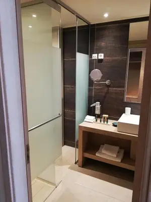 a bathroom with a sink and a shower at Aquagrand Artistic Luxury Beach Resort - Adults Only in Líndos