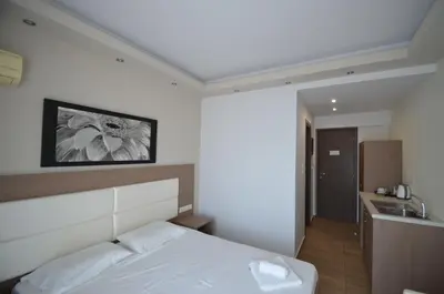 a hotel room with a bed and a sink at Sevastos Studios in Faliraki