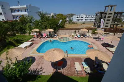 an overhead view of a swimming pool with umbrellas at Sevastos Studios in Faliraki
