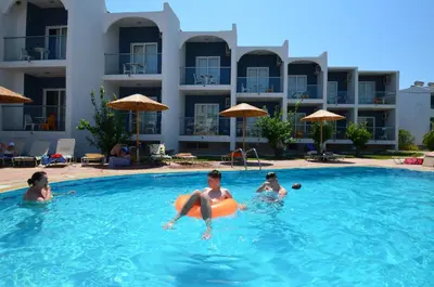 a group of people playing in a swimming pool at Sevastos Studios in Faliraki