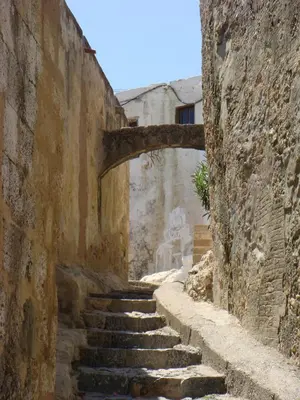 an alley with stone steps in an old building at Lindos Panorama in Líndos