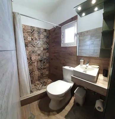a bathroom with a toilet and a sink at George Studios Pefkos in Pefki Rhodes