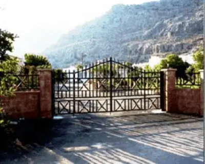 a metal gate with a view of a mountain at George Studios Pefkos in Pefki Rhodes