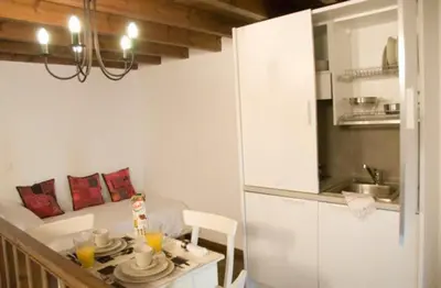 a small kitchen with a table and a dining room at Domus Studios in Rhodes Town