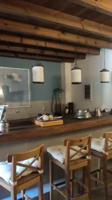 a kitchen with two chairs and a counter with lights at Domus Studios in Rhodes Town