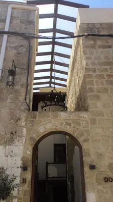 an entrance to a stone building with a glass roof at Domus Studios in Rhodes Town