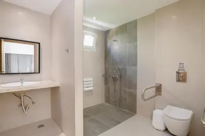 a bathroom with a shower and a toilet and a sink at Matina Pefkos Aparthotel in Pefki Rhodes