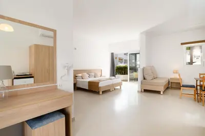 a living room with a bed and a couch at Matina Pefkos Aparthotel in Pefki Rhodes