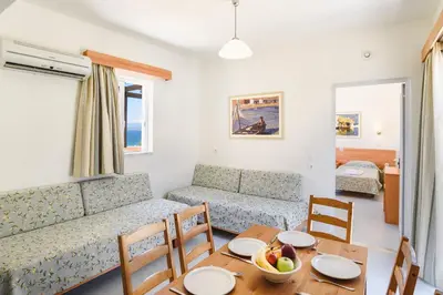 a living room with a couch and a table at Matina Pefkos Aparthotel in Pefki Rhodes