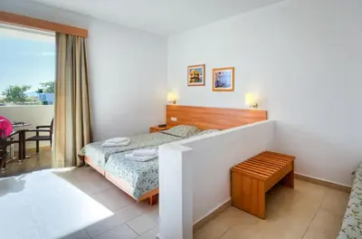 a hotel room with a bed and a table at Matina Pefkos Aparthotel in Pefki Rhodes