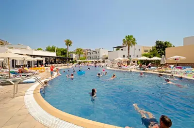 a group of people swimming in a swimming pool at Matina Pefkos Aparthotel in Pefki Rhodes