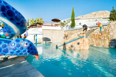 a pool with a pirate ship in the water at Porto Angeli in Archangelos