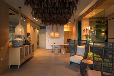 a lobby with a table and chairs in a building at Porto Angeli in Archangelos