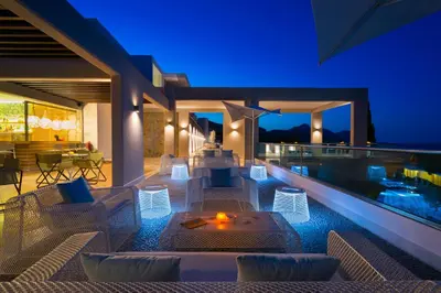 an outdoor patio of a villa at night at Porto Angeli in Archangelos