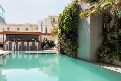 a swimming pool in the middle of a building at Manousos City Hotel in Rhodes Town