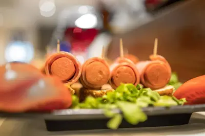 a plate of food with a sandwich on a table at Manousos City Hotel in Rhodes Town