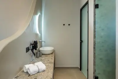 a bathroom with a sink and a counter with towels at Celestial Lindos Suites in Líndos
