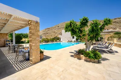 a patio with a tree and a swimming pool at Celestial Lindos Suites in Líndos