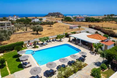 an aerial view of a swimming pool with chairs and umbrellas at Celestial Lindos Suites in Líndos