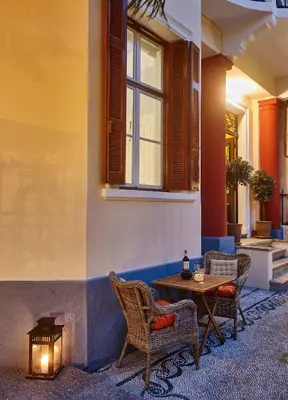 a patio with two chairs and a table with a candle at Villa Sanyan - Adults Only in Rhodes Town
